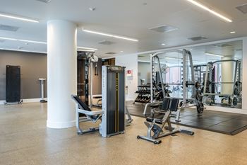 a gym with weights and cardio equipment in the wellness center